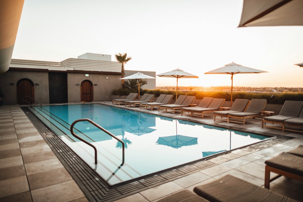 Swimming pool with clear blue water and a landscaped sun terrace